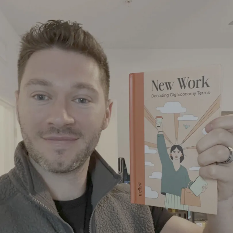 Matthew Mottola, CEO of Human Cloud, holding the New Work book